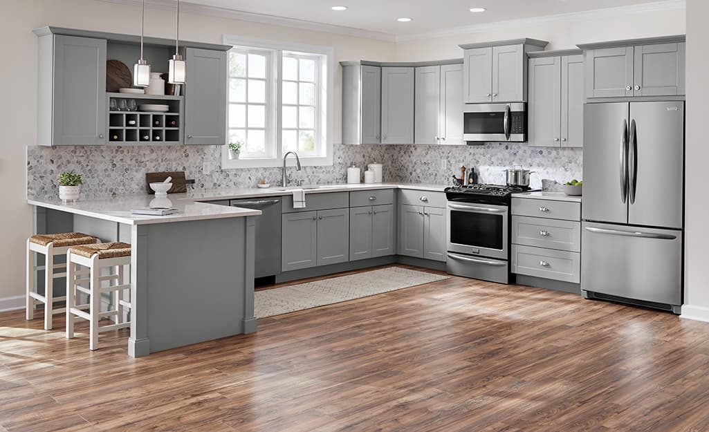 Remodeled kitchen with gray cabinets and light gray granite countertops