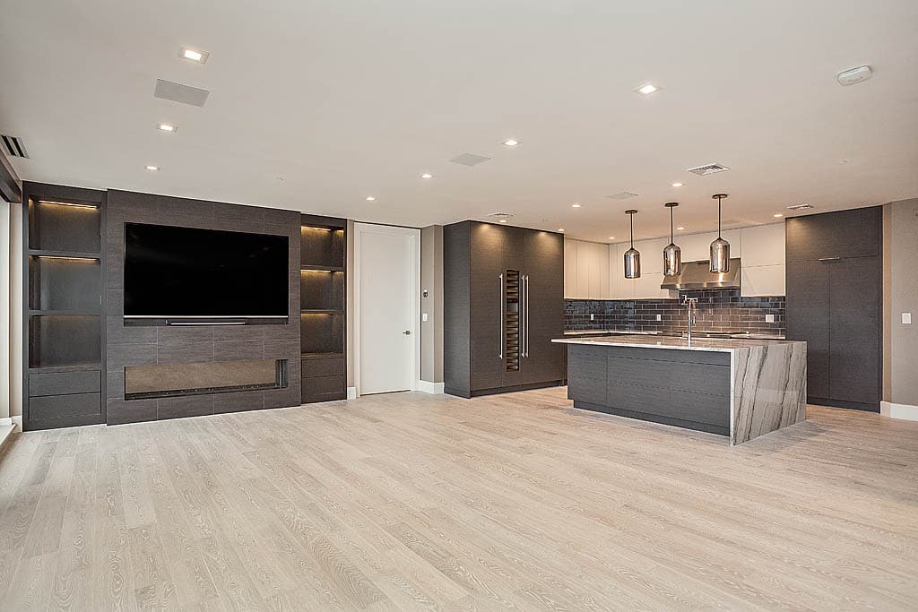 Remodeled kitchen with light gray granite countertops and white cabinets